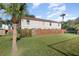 Backyard with lawn, wooden fence, and a palm tree at 980 Canal View Blvd # G1, Port Orange, FL 32129