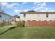 Lawn area with wooden fence and a building in the background at 980 Canal View Blvd # G1, Port Orange, FL 32129