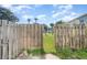 Backyard with wooden fence and access gate at 980 Canal View Blvd # G1, Port Orange, FL 32129