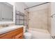 Bathroom with tub, wood vanity, and neutral tile at 980 Canal View Blvd # G1, Port Orange, FL 32129