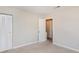 Simple bedroom with neutral walls, carpet, and a door to the bathroom at 980 Canal View Blvd # G1, Port Orange, FL 32129