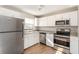 Updated kitchen with white cabinets and stainless steel appliances at 980 Canal View Blvd # G1, Port Orange, FL 32129