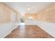 Bright living room with white wainscoting and wood-look floors at 980 Canal View Blvd # G1, Port Orange, FL 32129