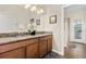 Elegant bathroom with double vanity, granite countertops, and access to a shower at 1463 Myrtlewood St, Davenport, FL 33896