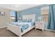 Main bedroom with a king-size bed, light blue color scheme, and ample natural light at 1463 Myrtlewood St, Davenport, FL 33896
