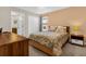 Spacious bedroom with a double bed, wooden nightstand, and built-in closet at 1463 Myrtlewood St, Davenport, FL 33896