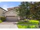 Two-story house with a two-car garage and landscaped lawn at 1463 Myrtlewood St, Davenport, FL 33896