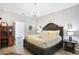 Main bedroom with king-size bed and elegant chandelier at 2541 Shanti Dr, Kissimmee, FL 34746