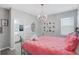 Elegant bedroom with a large bed, chandelier, and ensuite bathroom at 2541 Shanti Dr, Kissimmee, FL 34746