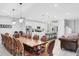 Large dining room with a long wooden table and leather chairs at 2541 Shanti Dr, Kissimmee, FL 34746