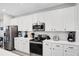 Modern kitchen with white cabinets, stainless steel appliances, and quartz countertops at 2541 Shanti Dr, Kissimmee, FL 34746
