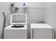 Convenient laundry room with washer, dryer, and shelving at 2541 Shanti Dr, Kissimmee, FL 34746