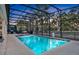 Enclosed rectangular pool with spa and a view of trees at 2541 Shanti Dr, Kissimmee, FL 34746