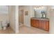 Bathroom with shower, toilet, double vanity, and granite countertop at 501 Lasso Dr, Kissimmee, FL 34747