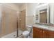 Bathroom with shower, toilet, granite vanity, and wood cabinets at 501 Lasso Dr, Kissimmee, FL 34747