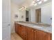 Double vanity bathroom with granite countertop and wood cabinets at 501 Lasso Dr, Kissimmee, FL 34747