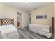 Bedroom with two twin beds, en-suite bathroom access, and gray floors at 501 Lasso Dr, Kissimmee, FL 34747