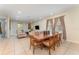 Dining room with wooden table and six chairs, adjacent to living room at 501 Lasso Dr, Kissimmee, FL 34747