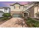 Two-story house with stone accents and a two-car garage at 501 Lasso Dr, Kissimmee, FL 34747