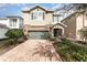 Two-story house with stone accents and a two-car garage at 501 Lasso Dr, Kissimmee, FL 34747