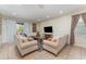 Spacious living room with light beige sofas and a large TV at 501 Lasso Dr, Kissimmee, FL 34747