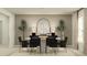 Modern dining room with round white table and six black chairs at 1348 Blue Ash Ln, Deland, FL 32720