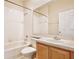 Clean bathroom with shower/tub combo and wood vanity at 1550 Cedar Lake Dr, Orlando, FL 32824