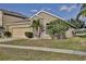 One-story house with red front door and landscaped yard at 1550 Cedar Lake Dr, Orlando, FL 32824