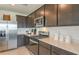 Modern kitchen with stainless steel appliances and dark brown cabinets at 264 Woodsage Pl, Lake Alfred, FL 33850