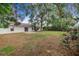 House backyard with grassy area and patio at 5880 Driftwood Dr, Winter Haven, FL 33884