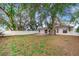 Backyard view of house, with grassy area and patio at 5880 Driftwood Dr, Winter Haven, FL 33884