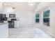 Bright kitchen with white cabinets and tile flooring at 5880 Driftwood Dr, Winter Haven, FL 33884