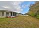 Landscaped backyard featuring a screened porch at 3379 Fiddle Leaf Way, Lakeland, FL 33811