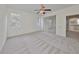 Well-lit bedroom featuring a ceiling fan and access to a screened lanai at 3379 Fiddle Leaf Way, Lakeland, FL 33811