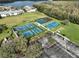 Aerial view of community amenities including tennis courts, basketball court, playground, and parking at 3379 Fiddle Leaf Way, Lakeland, FL 33811
