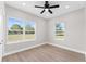 Bright bedroom with ceiling fan and wood-look floors at 6085 Lightsey Rd, Fort Meade, FL 33841
