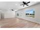 Spacious living area with light flooring and ceiling fans at 6085 Lightsey Rd, Fort Meade, FL 33841