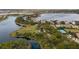 Beautiful aerial shot featuring manicured lawns, mature trees, and a community tennis court by a lake at 7833 Freestyle Ln, Winter Garden, FL 34787