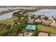 Drone shot of community amenities like tennis courts, green space, and elegant residences near the waterfront at 7833 Freestyle Ln, Winter Garden, FL 34787