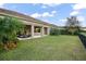 Enjoy the backyard featuring a covered patio and well-manicured lawn at 7833 Freestyle Ln, Winter Garden, FL 34787