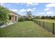 Expansive backyard with green lawn, black fence, and lush landscaping at 7833 Freestyle Ln, Winter Garden, FL 34787