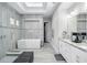 Bathroom featuring a walk-in shower, soaking tub, double sink vanity, and tile flooring at 7833 Freestyle Ln, Winter Garden, FL 34787