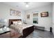 Bedroom with a dark wood bed frame, gray floors, flat screen television, and natural light from the window at 7833 Freestyle Ln, Winter Garden, FL 34787