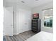 Comfortable bedroom with a gray dresser and a view from the window at 7833 Freestyle Ln, Winter Garden, FL 34787