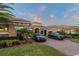 Beautiful Mediterranean-style home featuring a tile roof, arched entry, a brick driveway and two parked cars at 7833 Freestyle Ln, Winter Garden, FL 34787