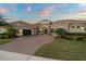 Charming single-story home featuring a tile roof and attached garage with a paved brick driveway and landscaped yard at 7833 Freestyle Ln, Winter Garden, FL 34787
