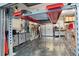 Spacious garage with metallic flooring, and an automotive lift, providing ample space for vehicle storage at 7833 Freestyle Ln, Winter Garden, FL 34787