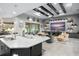 Open-concept kitchen with island flowing into living area featuring coffered ceiling and entertainment center at 7833 Freestyle Ln, Winter Garden, FL 34787