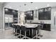 Modern kitchen with granite countertop island, stainless steel appliances, and dark cabinets at 7833 Freestyle Ln, Winter Garden, FL 34787
