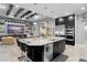 Open-concept kitchen with island flowing into living area featuring coffered ceiling and entertainment center at 7833 Freestyle Ln, Winter Garden, FL 34787